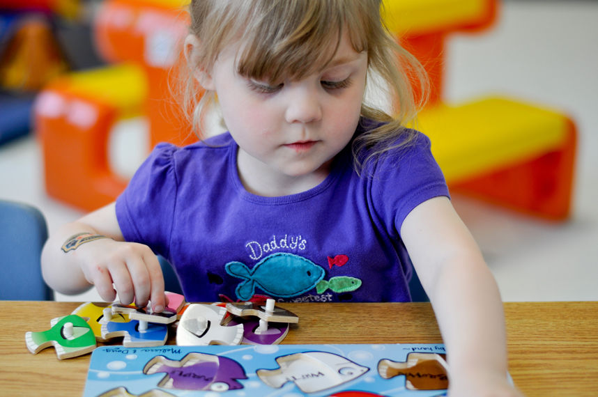 Child Playing with a fish puzzle | Simcoe Community Services