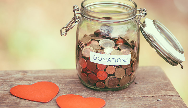 Donation jar filled with change | Simcoe Community Services