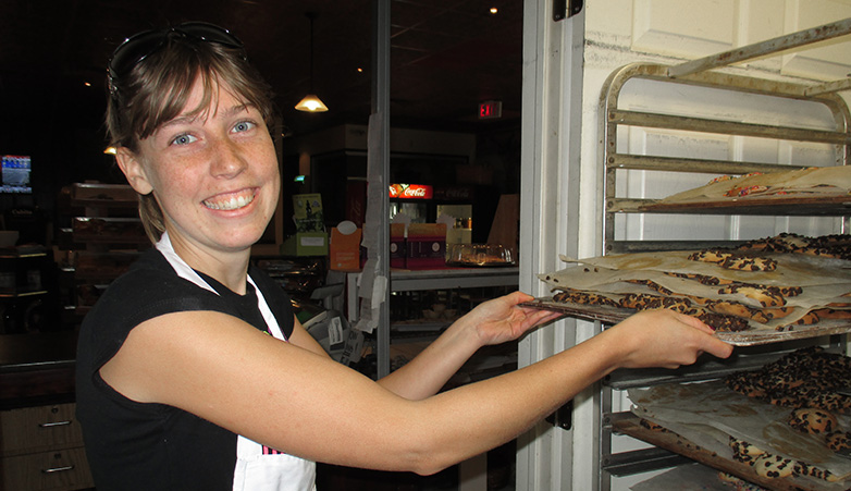 Katrina Putting about racks of cookies | Get Involved | Simcoe Community Services