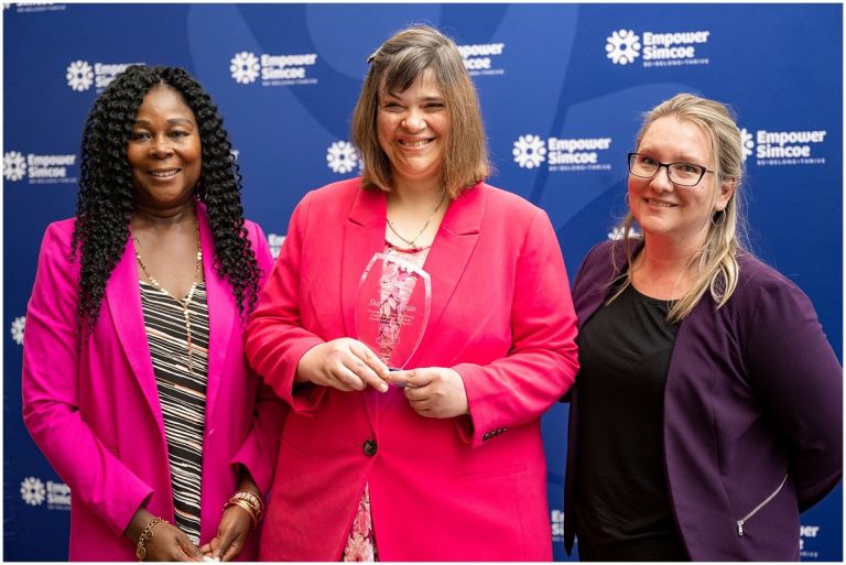 3 women taking picture at an awards presentation