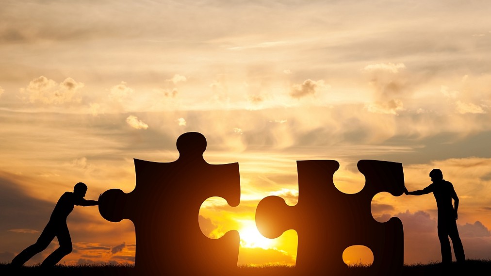 puzzle pieces in front of sunset