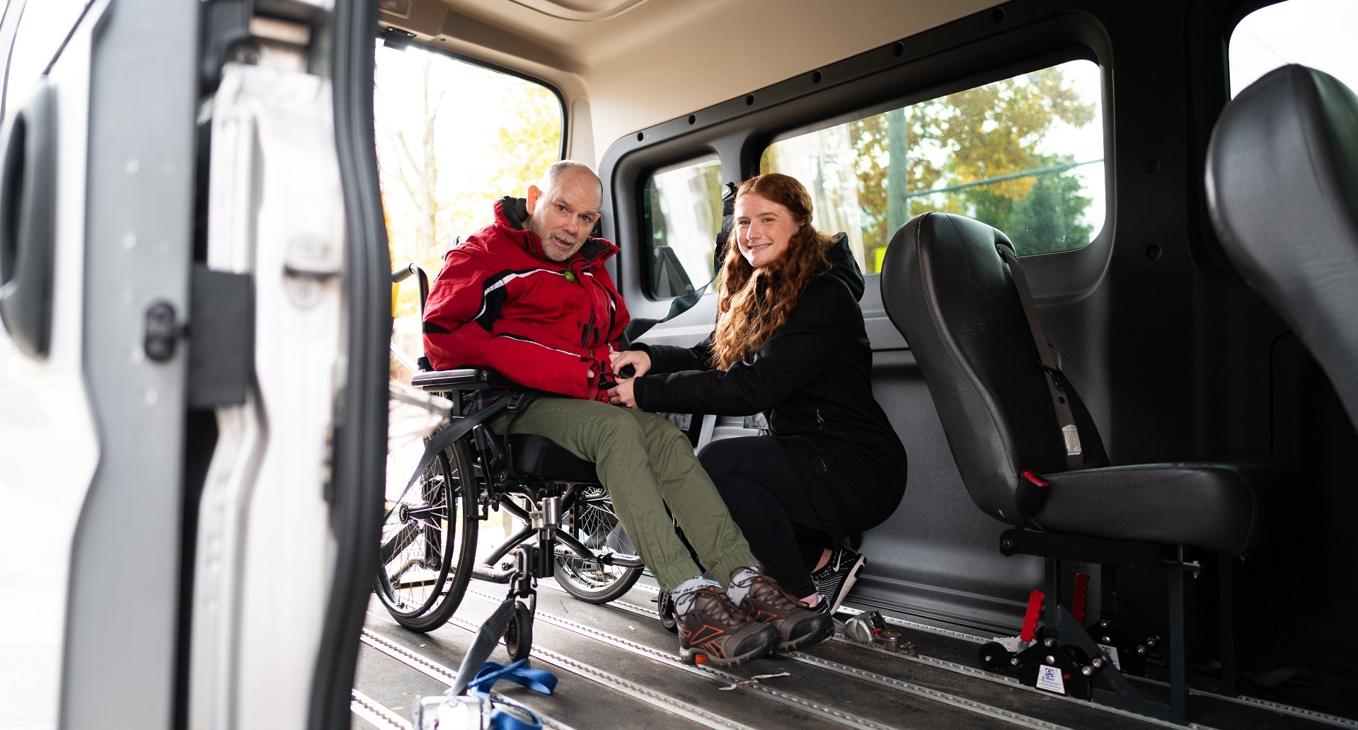 Young Empower Simcoe staff helping man in wheelchair