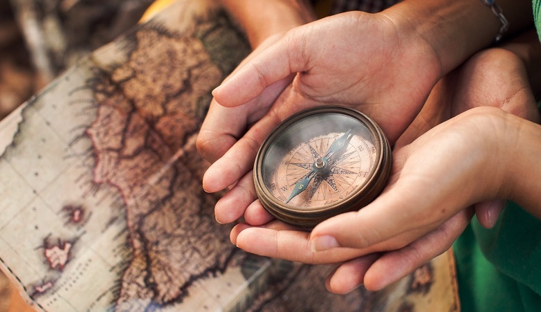 holding compass in hands