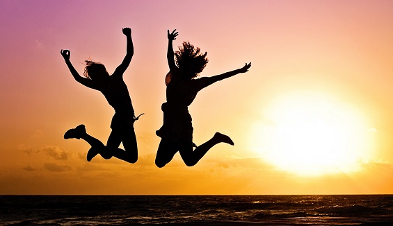 people jumping in front of sunset